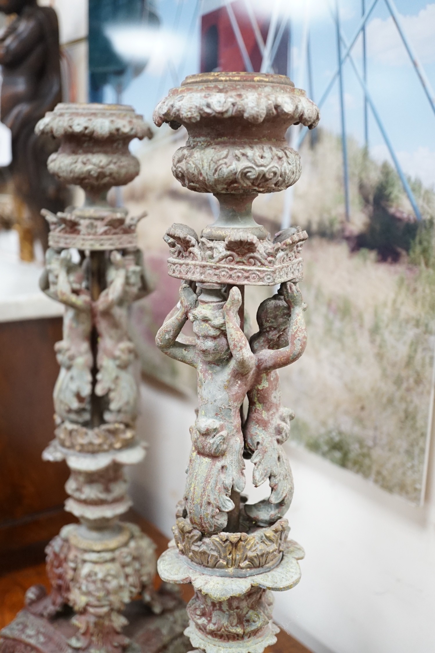 A pair French cast metal candlesticks. 47cm tall